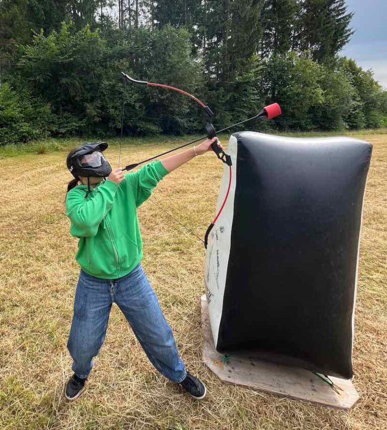 Summer camp participant doing archery